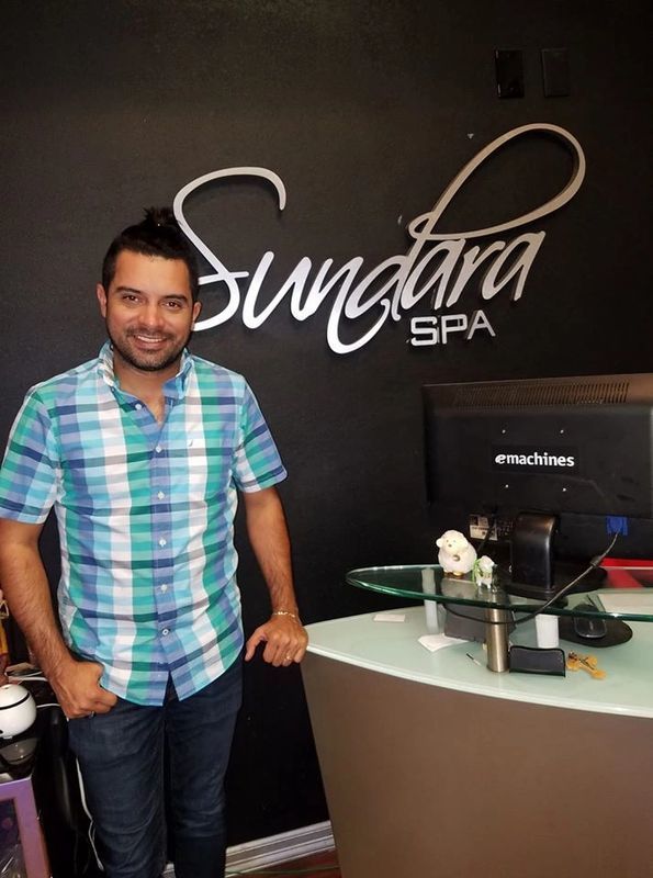 A man standing in the front office of Sundara Spa
